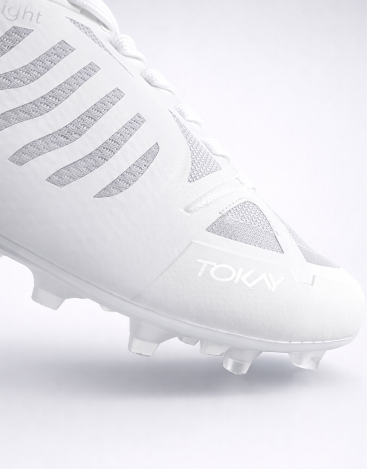 White ultimate frisbee cleat with gray accents on a light gray background showing the higher and wider toebox for extra comfort.